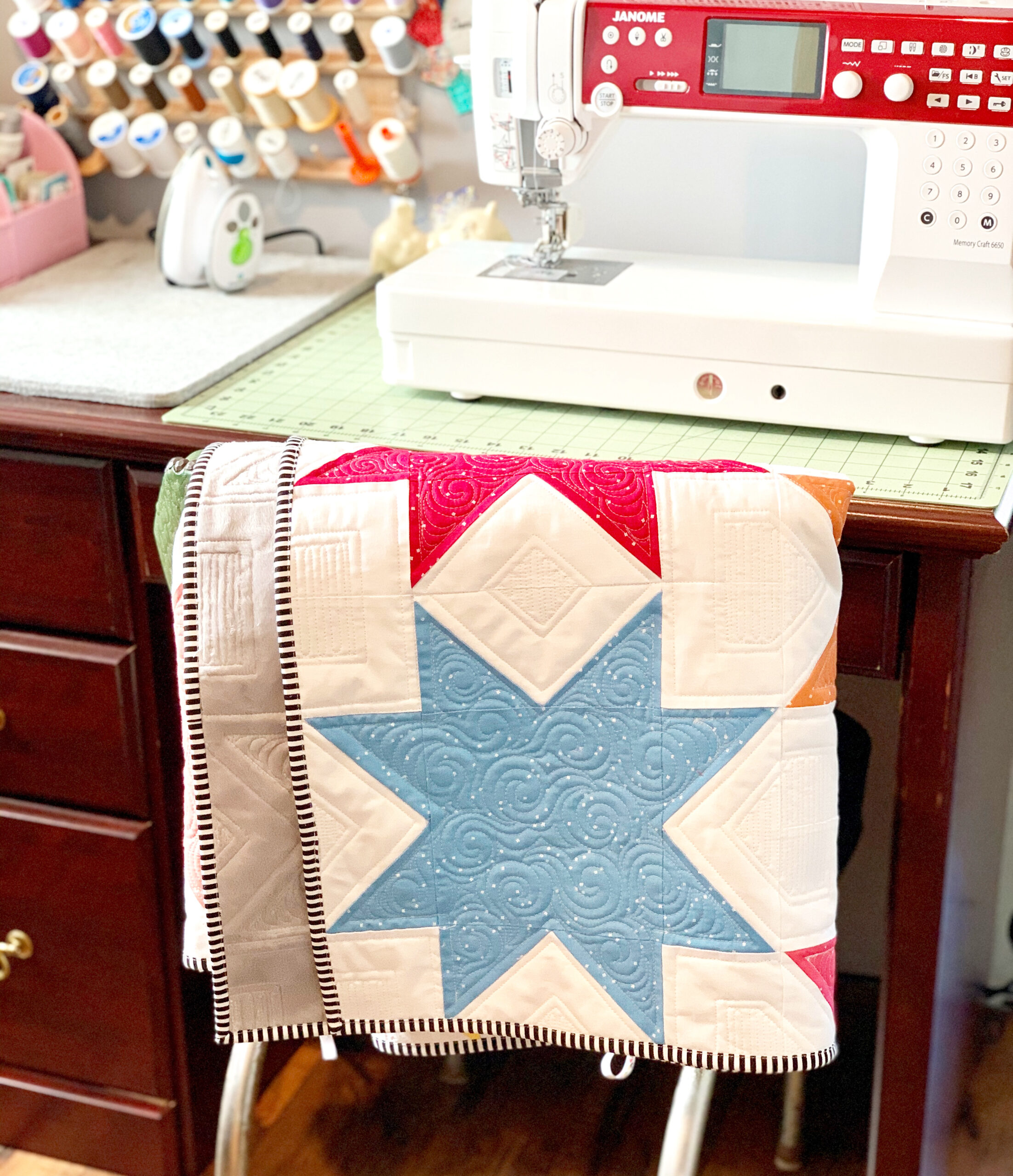 Offset Star Quilt Hanging over chair in sewing room 