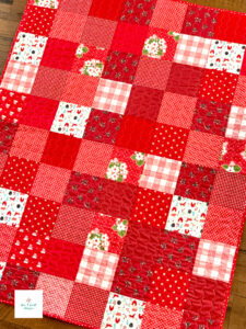 Crib Sized baby patchwork quilt in red scraps