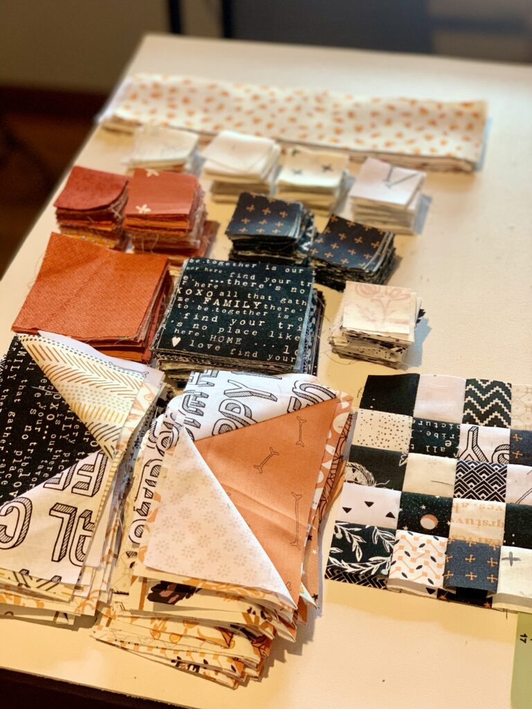 pieced and cut orange, black and low volume scraps for my scrappy picnic quilt pattern