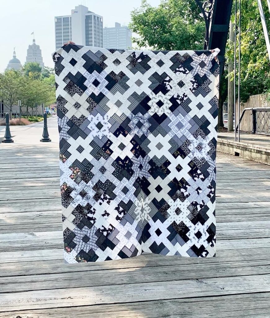 Black and white clover fields quilt pattern in scrap fabrics. 