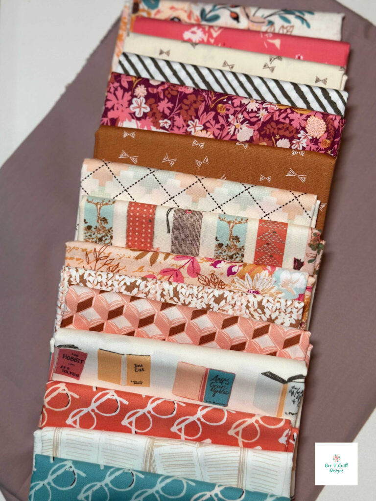A close-up of fabrics of the Love Letters quilt, showing the fine weave of Bookish Art Gallery Fabrics by Sharon Holland.