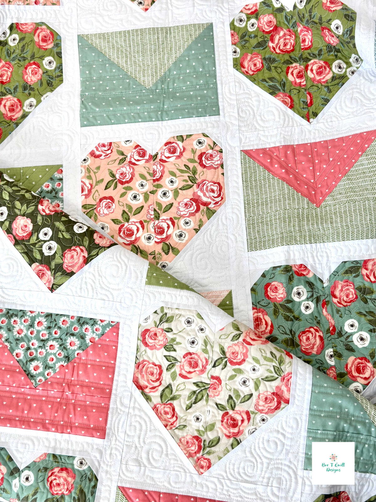 A neatly folded Love Letters quilt showing the texture and colors of this modern Valentine quilt pattern.