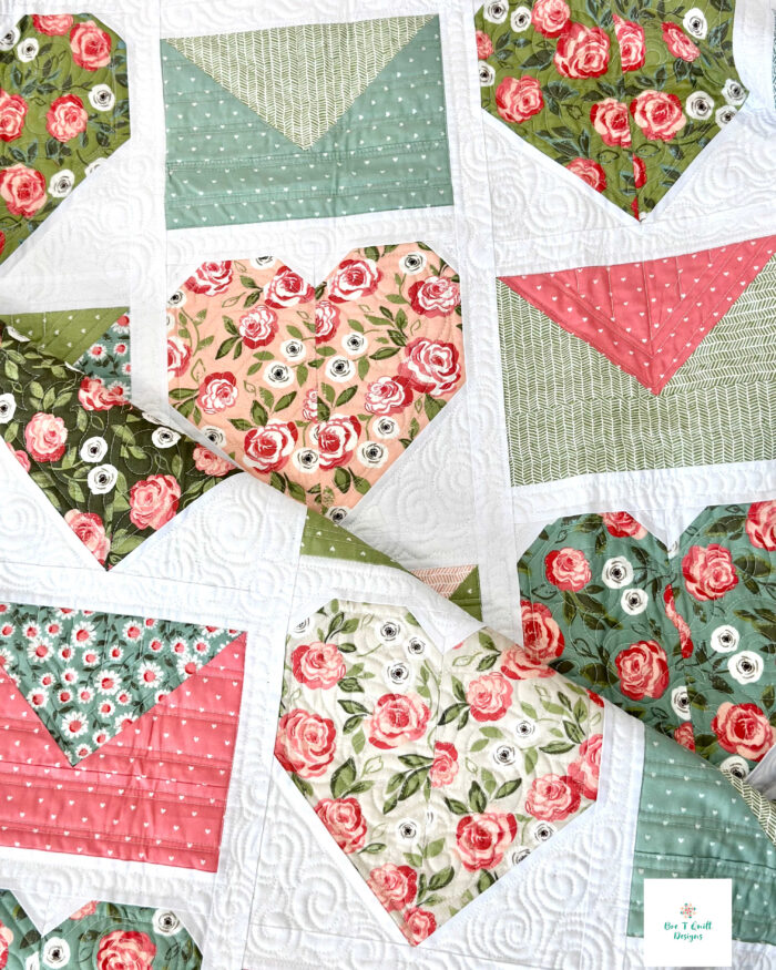 A neatly folded Love Letters quilt showing the texture and colors of this modern Valentine quilt pattern.