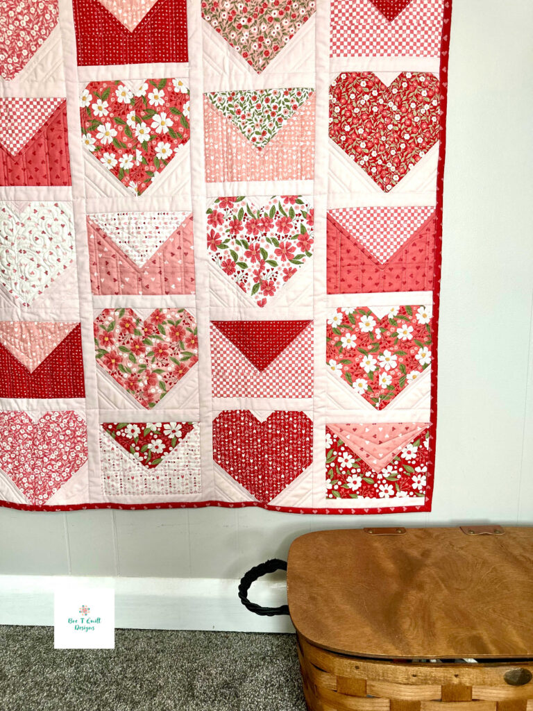 Red binding with small pink hearts on a Valentine’s Day heart quilt pattern