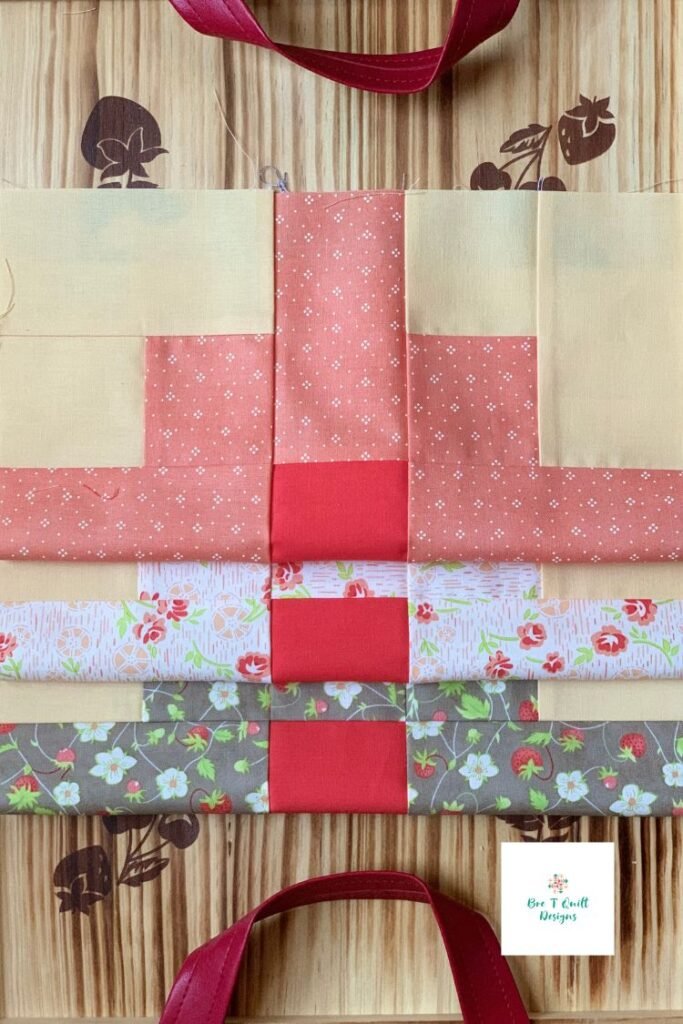 clover fields quilt blocks with yellow background and pink and brown fabric. 