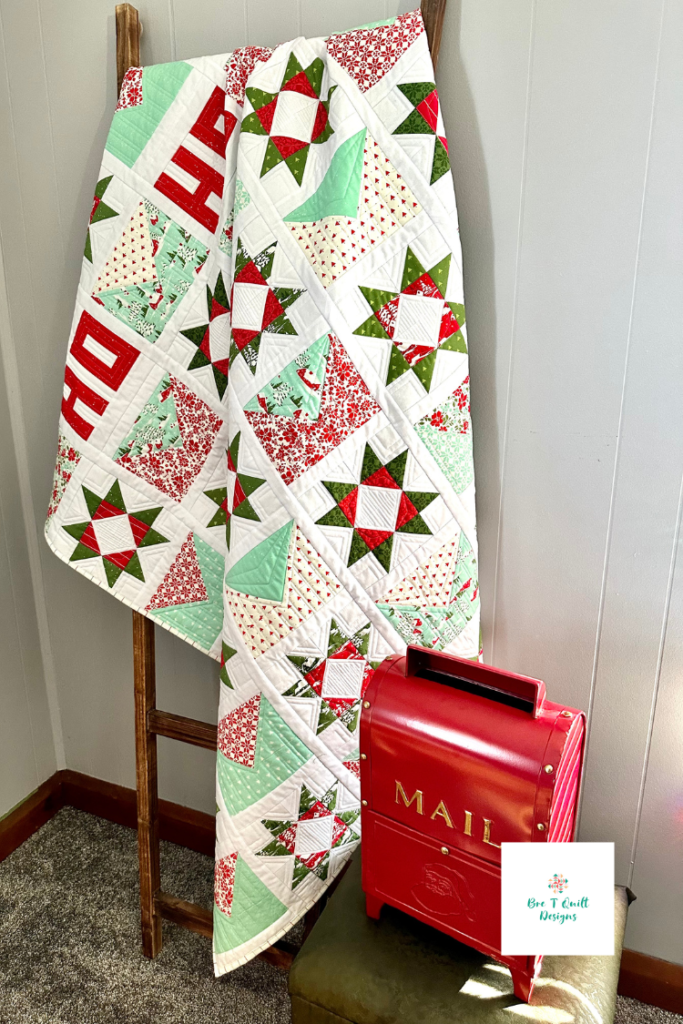 Letters For Santa Christmas quilt pattern sample draped over a quilt ladder for holiday decor