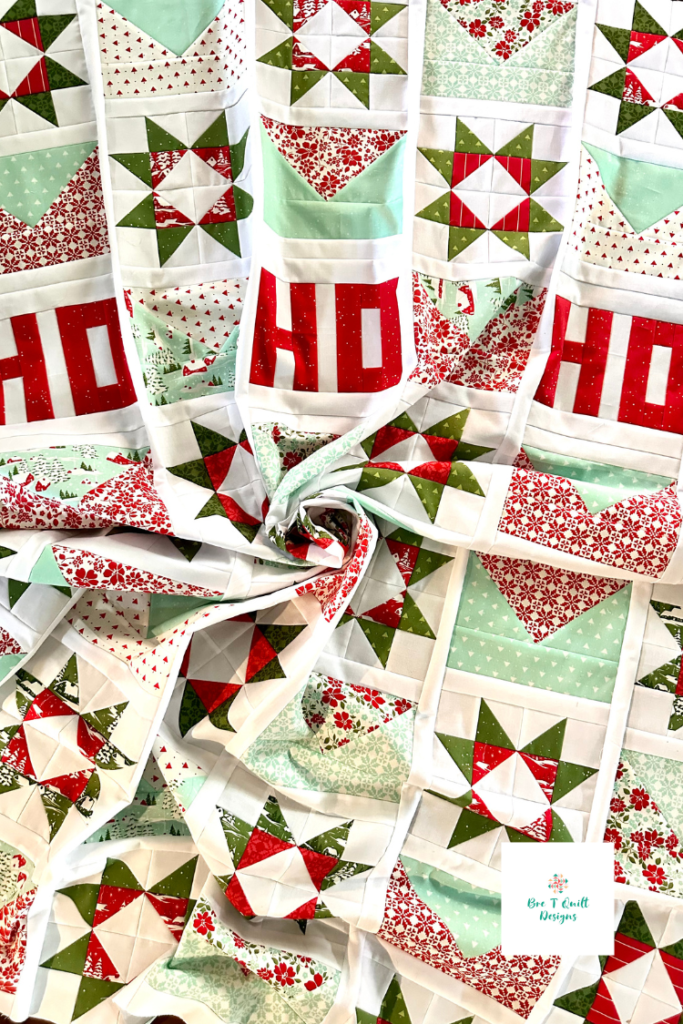 Close-up of the quilt top and letters in a quilt swirtl on the Letters For Santa Christmas quilt