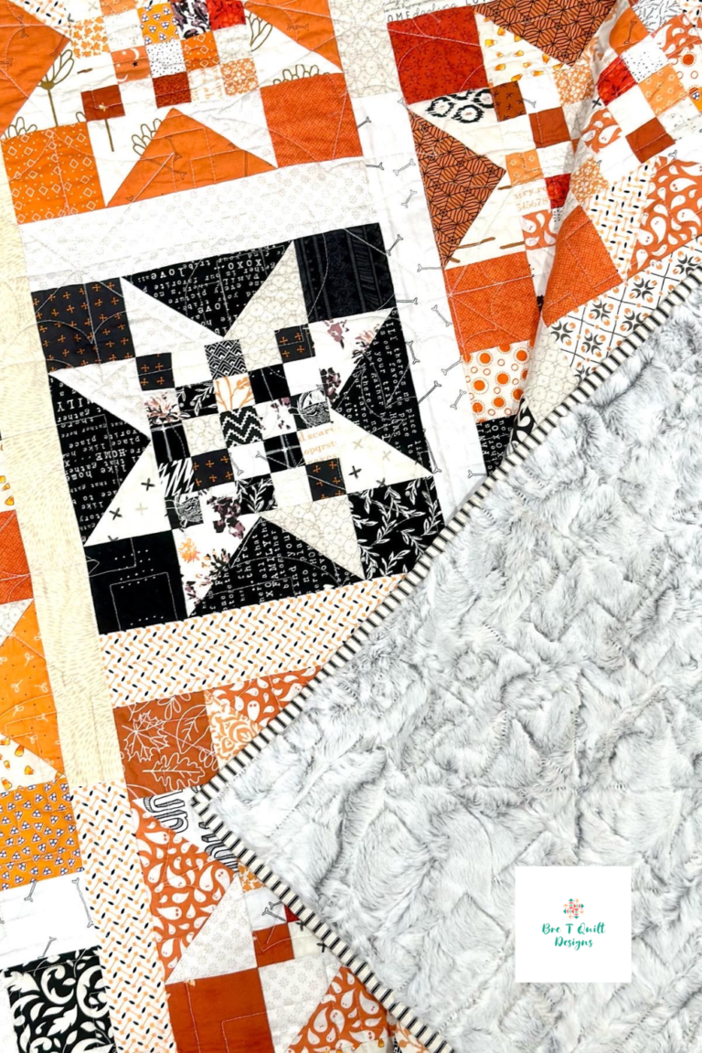 Close up of halloween quilt to show quilting, minky backing, and star block.