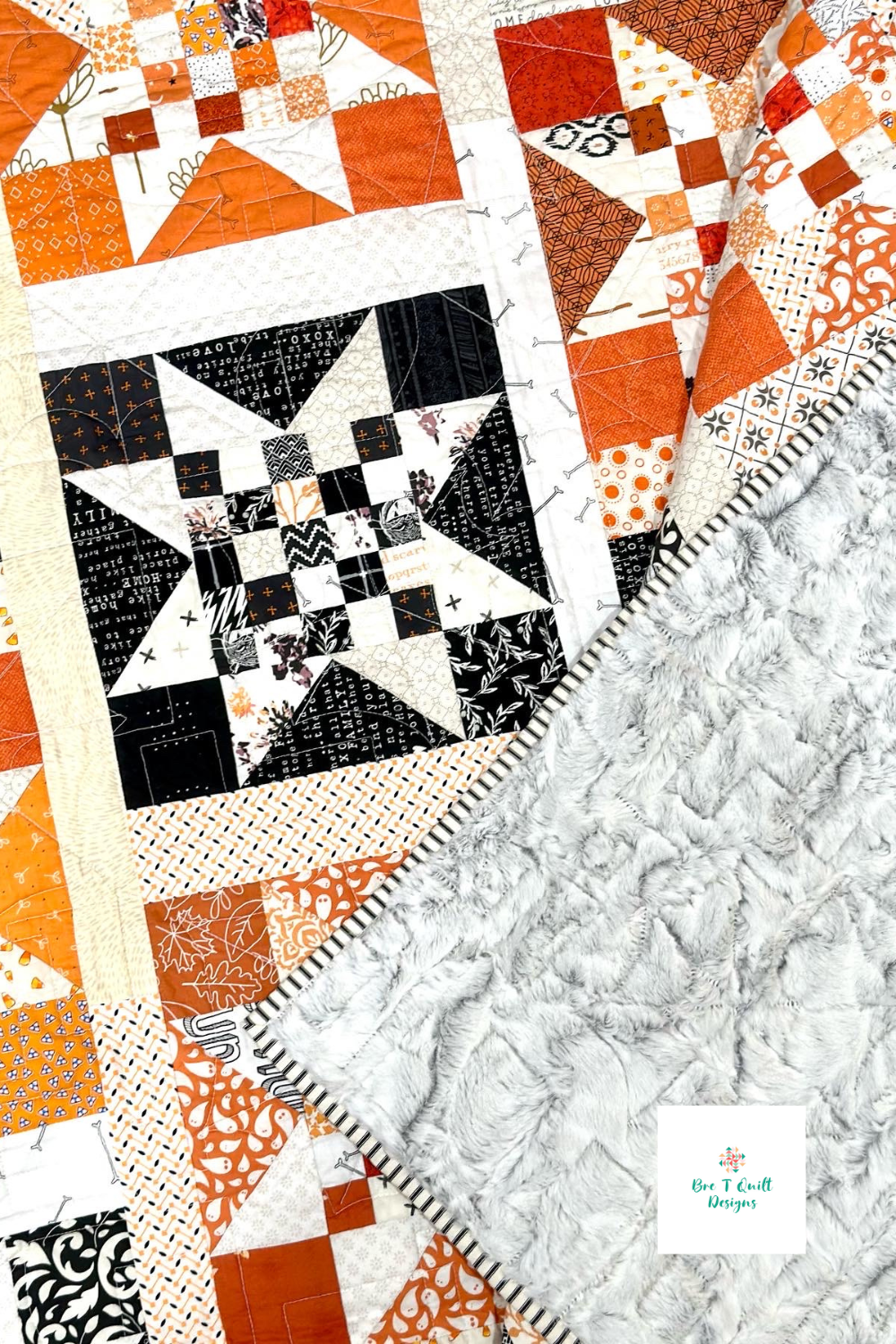 Close up of halloween quilt to show quilting, minky backing, and star block.