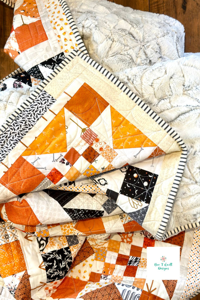 Halloween quilt bundled up in a heap of fabric.