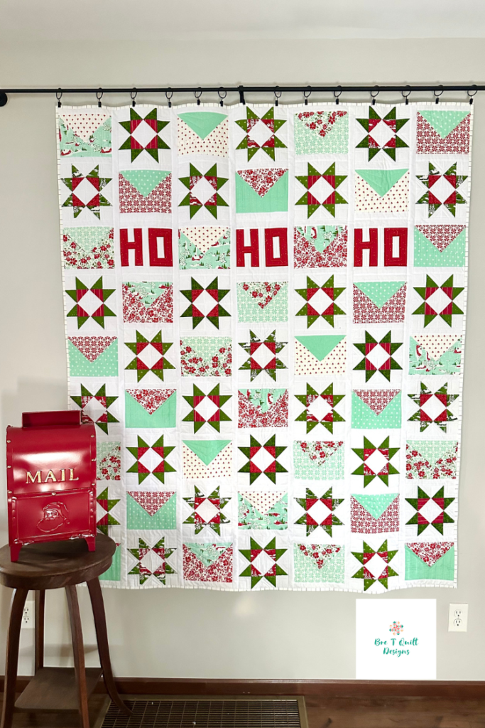 Full view of the Letters For Santa throw size Christmas quilt in red, green, and aqua